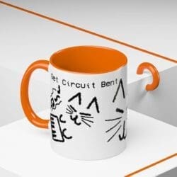 Photo of a mug featuring three poorly drawn cats with the text "Get Circuit Bent"
